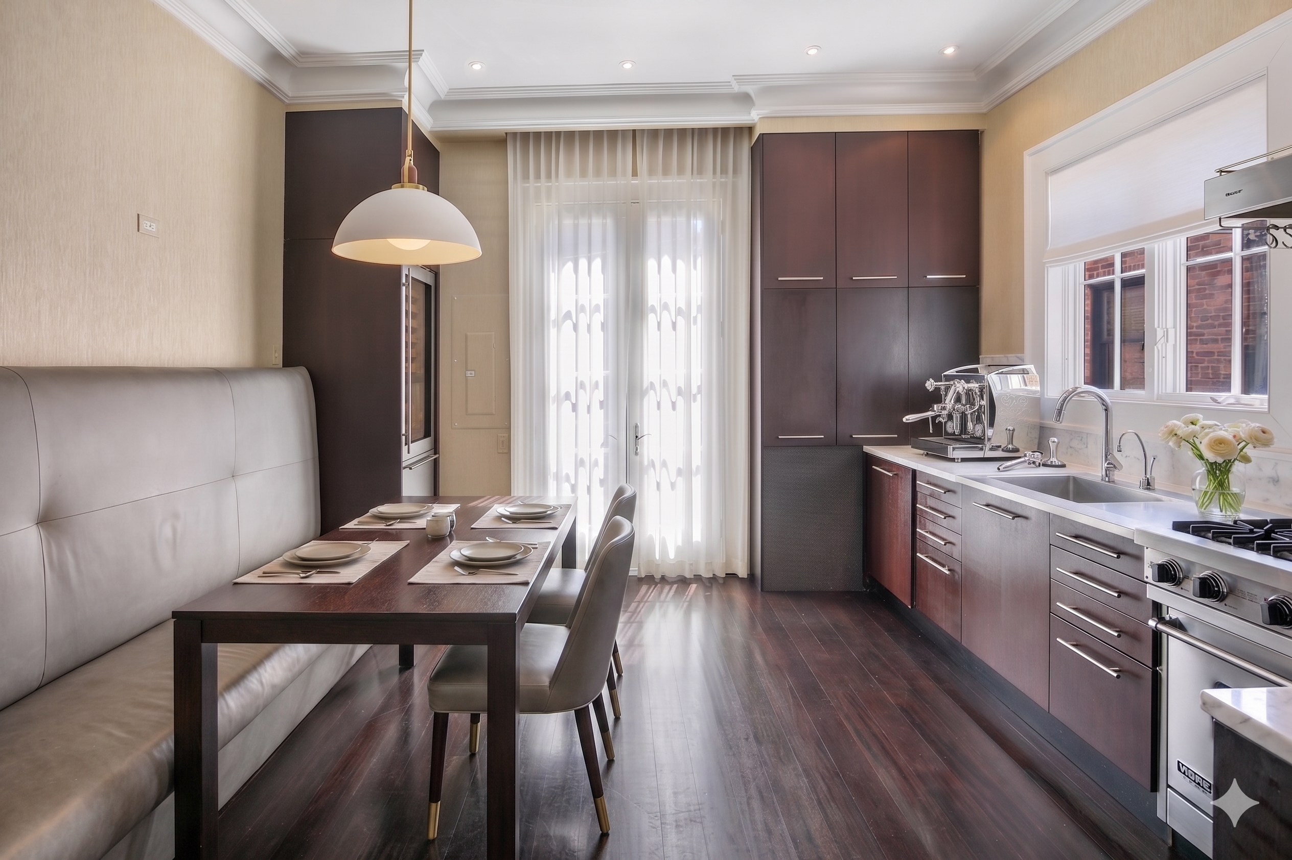 1832 Corcoran Street Northwest Washington, DC 20009 - Photo 5 of 29 a kitchen with a table chairs refrigerator and cabinets