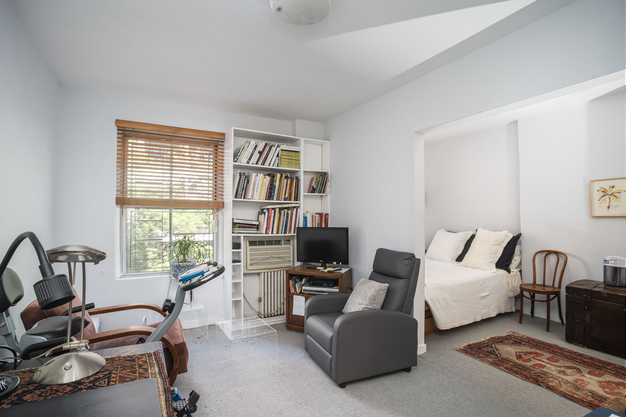 206 East 30th Street Manhattan, NY 10016 - Photo 13 of 21 a living room with furniture and a flat screen tv