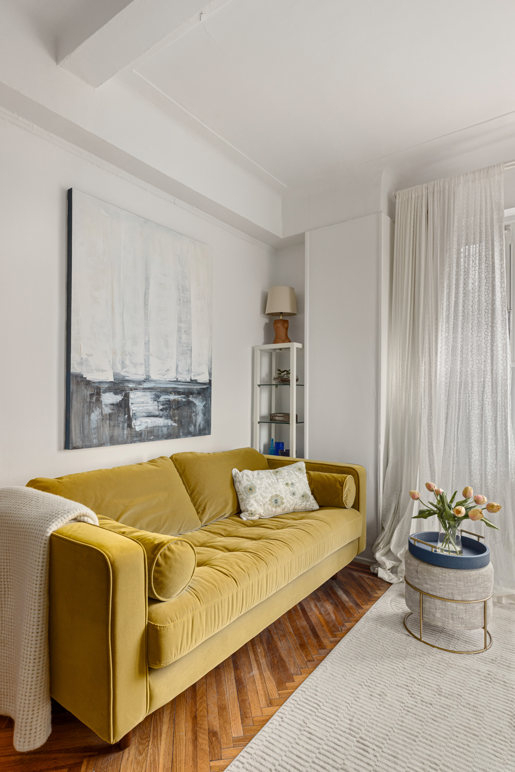 233 West 99th Street, Unit 19A Manhattan, NY 10025 - Photo 5 of 10 a living room with a couch and a table