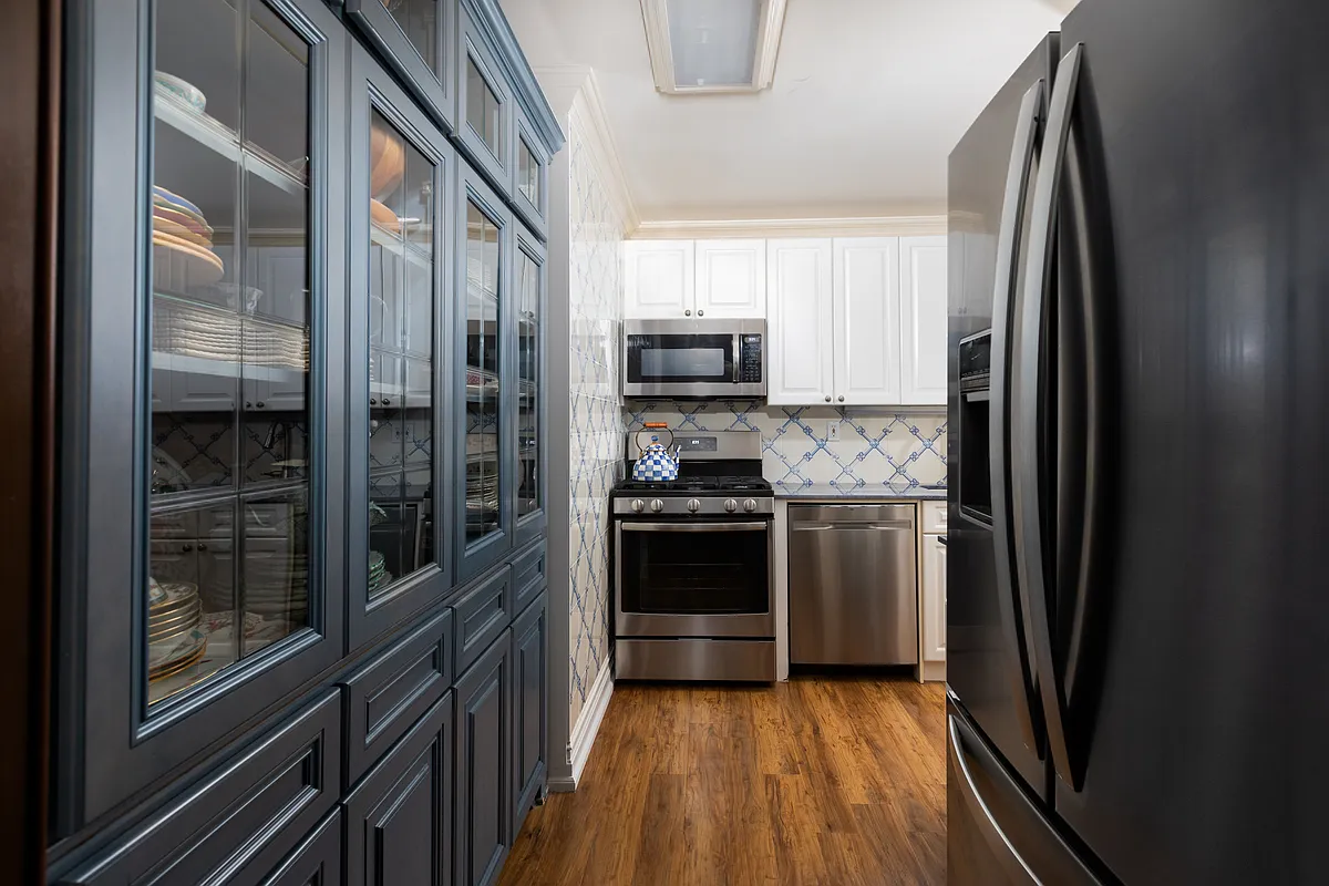 404 East 76th Street, Unit 30C Manhattan, NY 10021 - Photo 13 of 24 a kitchen with stainless steel appliances granite countertop a refrigerator and a sink
