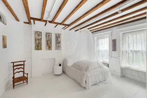 a spacious bedroom with a bed and a window