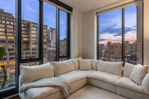 a living room with furniture with a large window