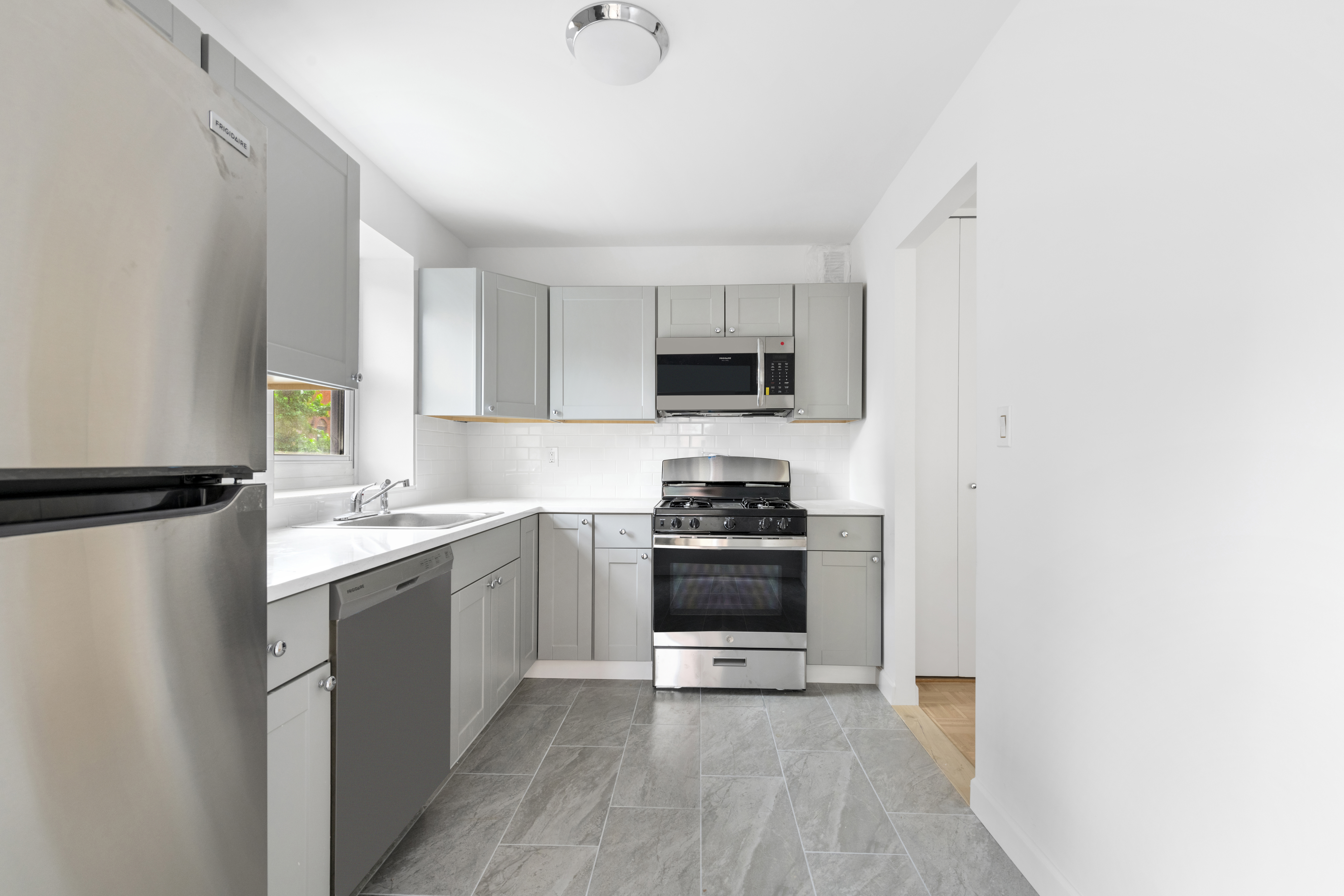 100 West 89th Street, Unit 3E Manhattan, NY 10024 - Photo 4 of 19 a kitchen with stainless steel appliances granite countertop a stove a sink and a refrigerator