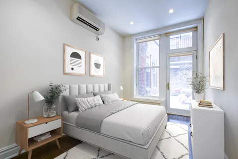 a bedroom with a bed and a couch