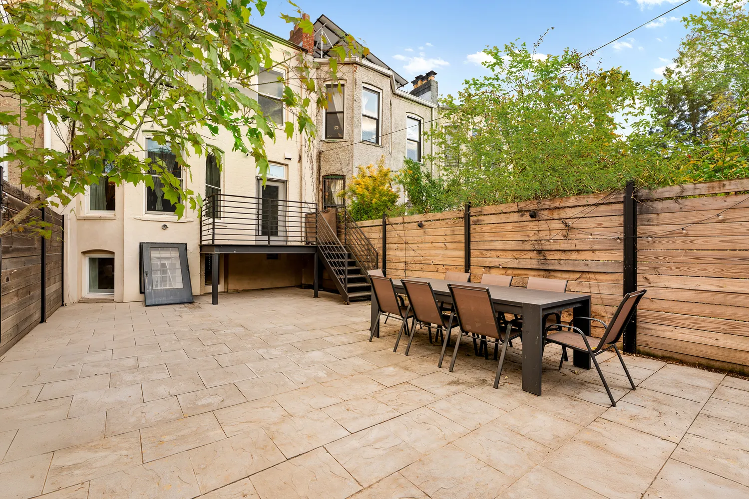 a view of a patio with table and chairs and potted plants