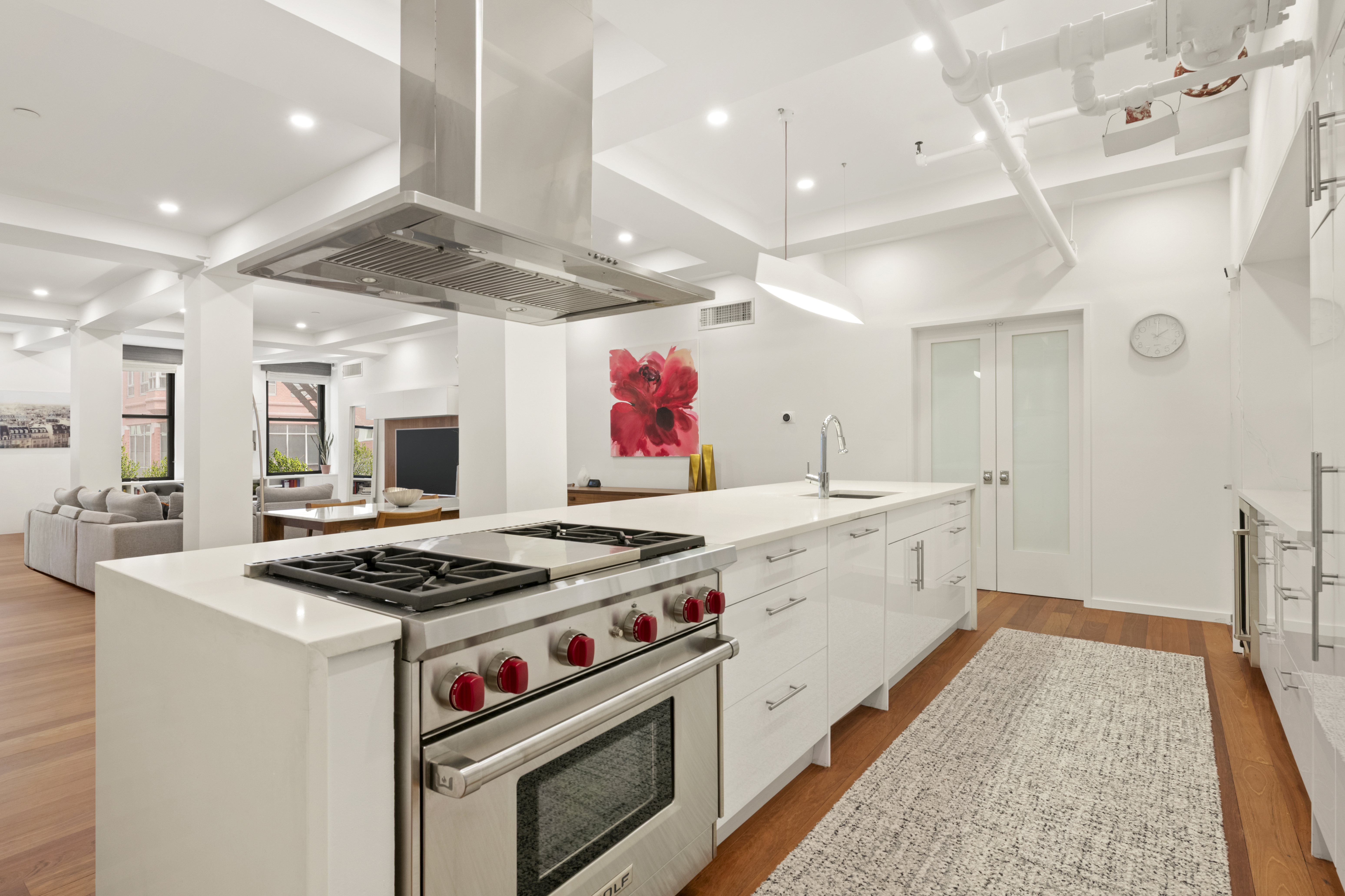110 Duane Street, Unit 3F Manhattan, NY 10007 - Photo 3 of 14 a kitchen with stainless steel appliances granite countertop a stove and a white cabinets