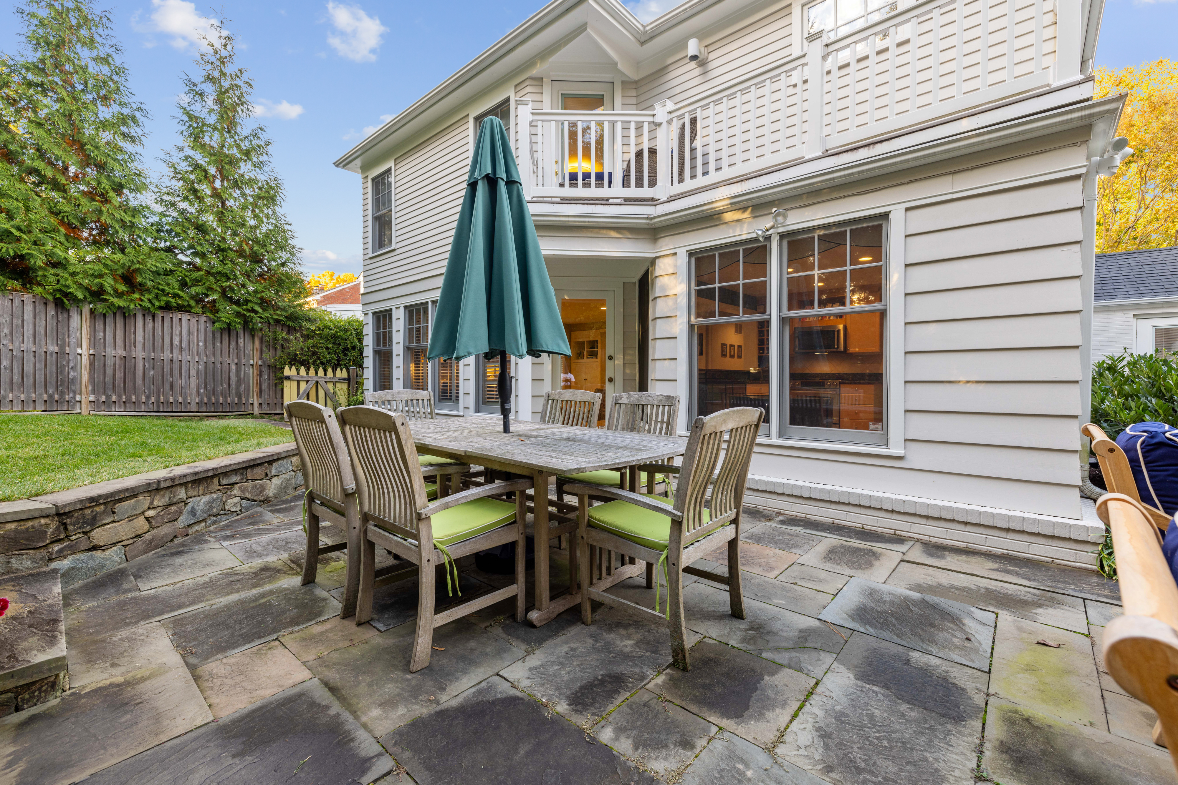 5016 Allan Road Bethesda, MD 20816 - Photo 4 of 4 a view of a patio with table and chairs with wooden fence and plants