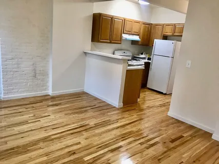 a view of kitchen with wooden floor and electronic appliances