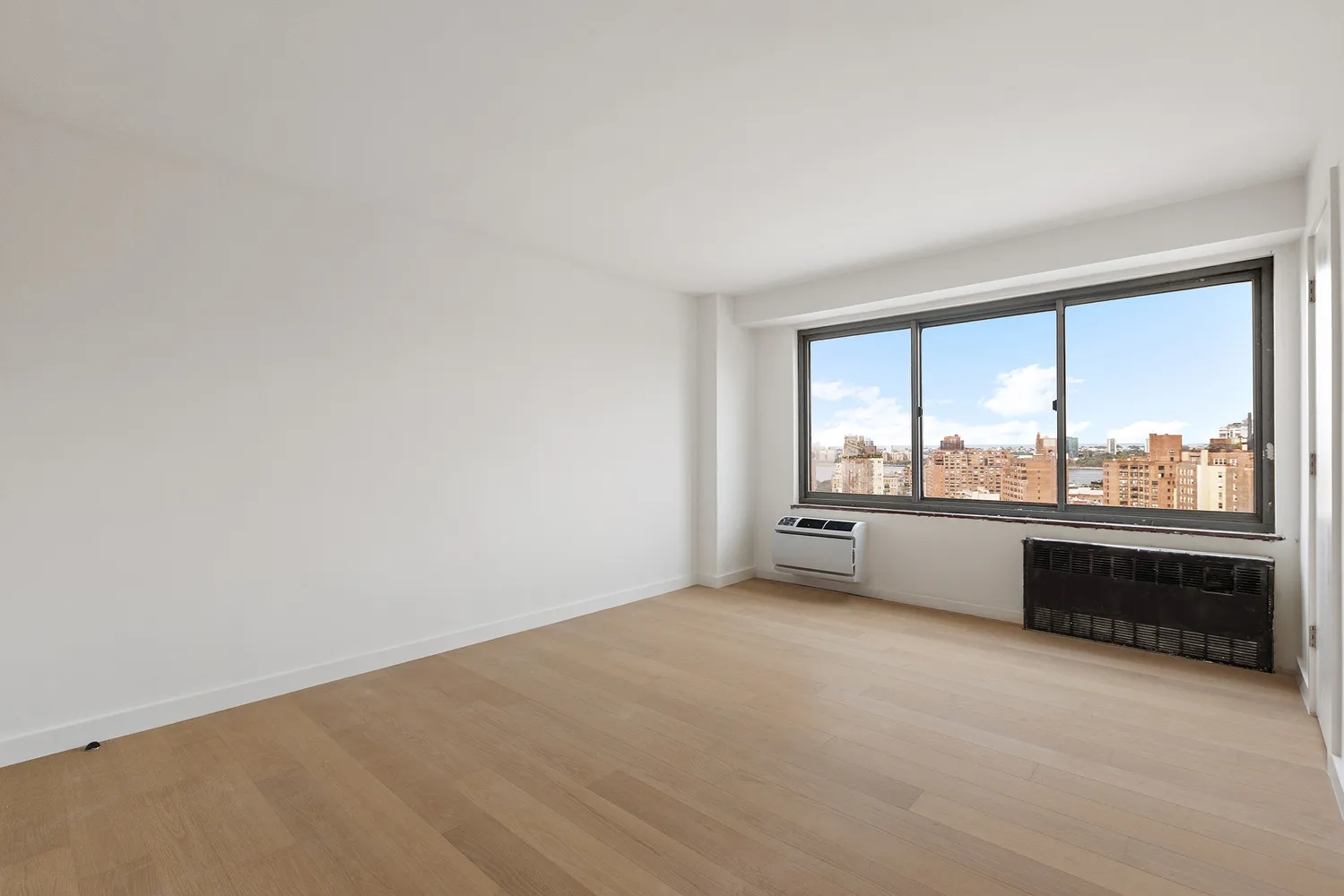 an empty room with large windows