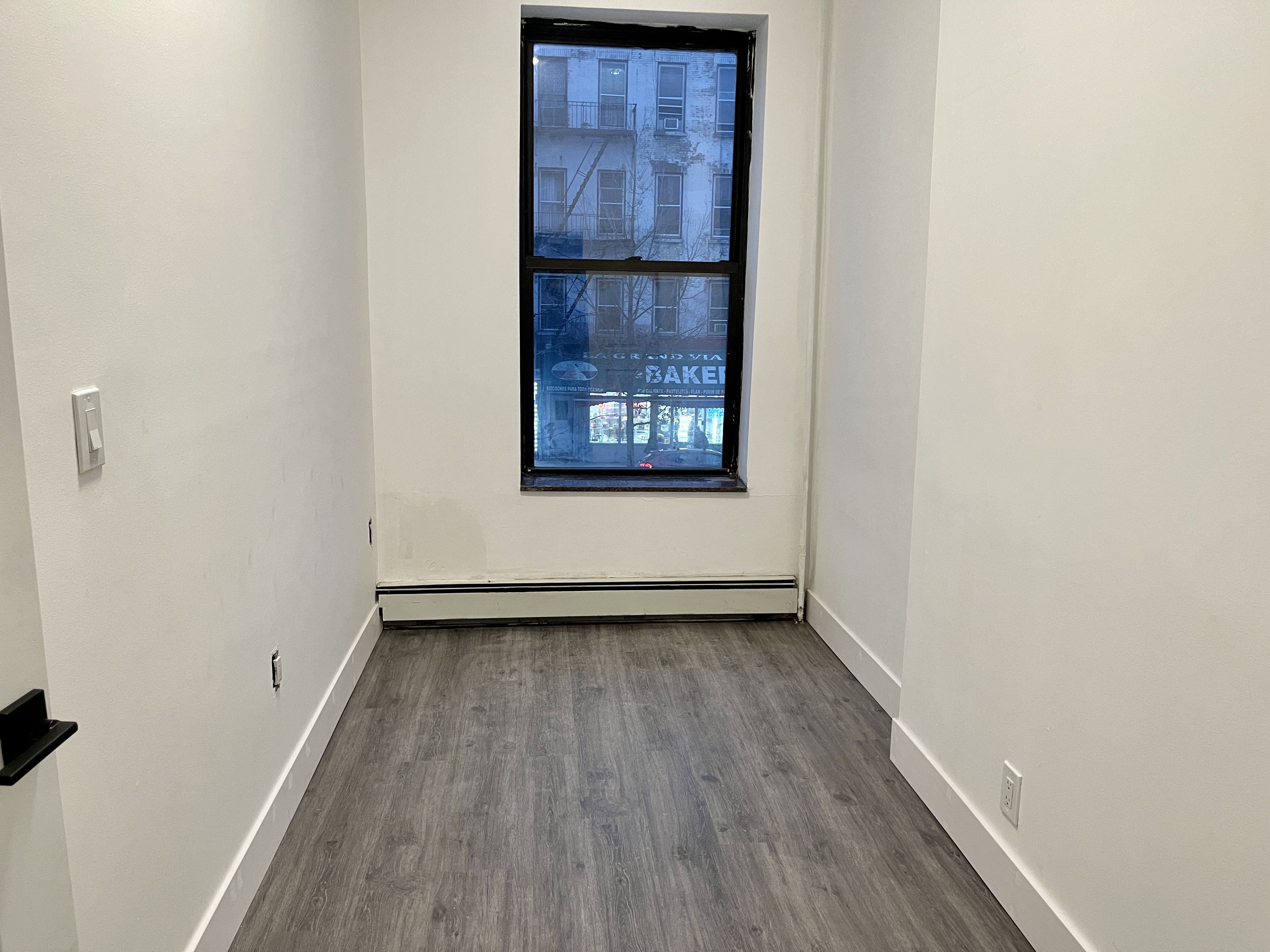 1999 3rd Avenue, Unit 1 Manhattan, NY 10029 - Photo 14 of 23 a view of a room with wooden floor and staircase