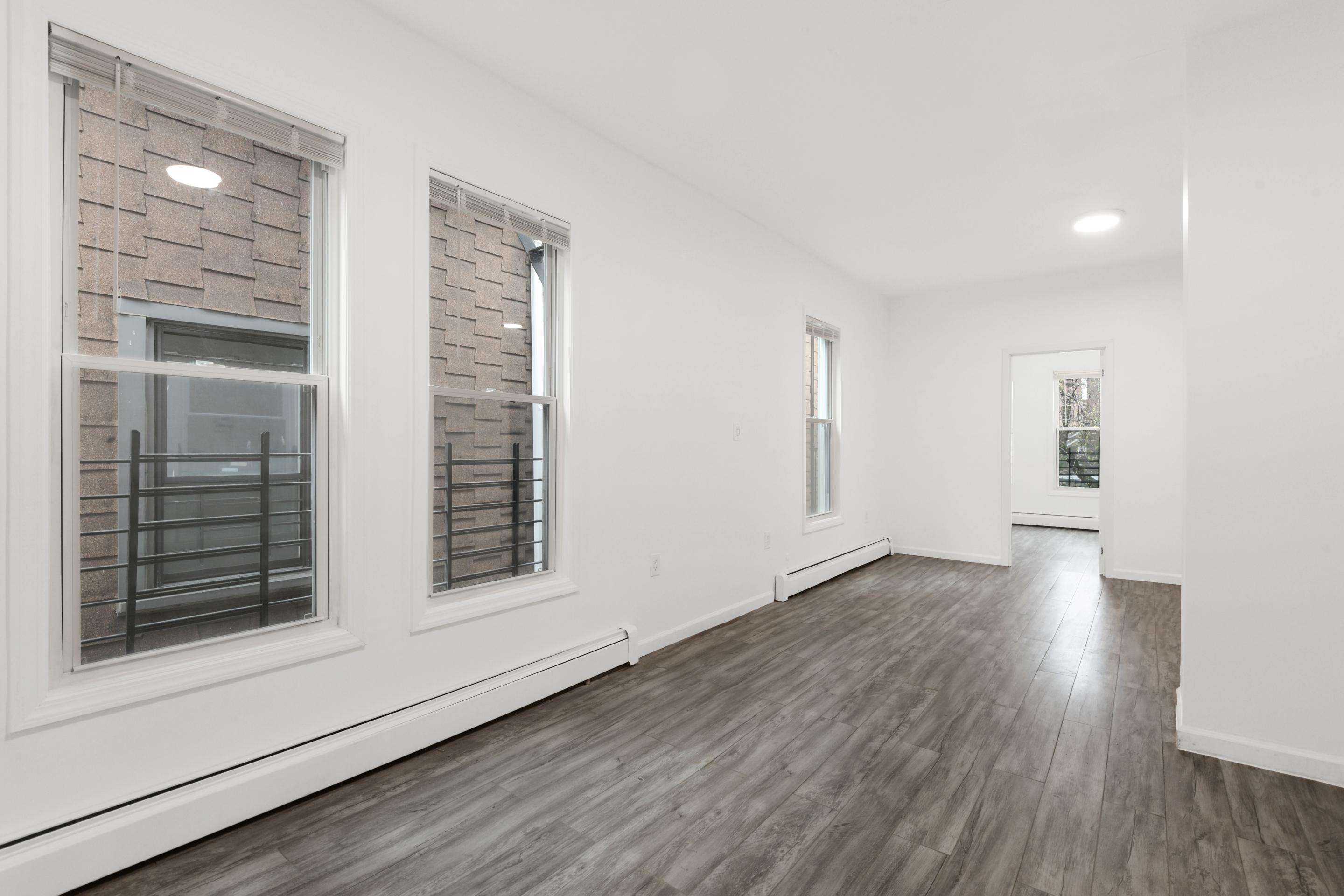 332 East 198th Street, Unit 2 Bronx, NY 10458 - Photo 6 of 10 a view of wooden floor and windows in a room