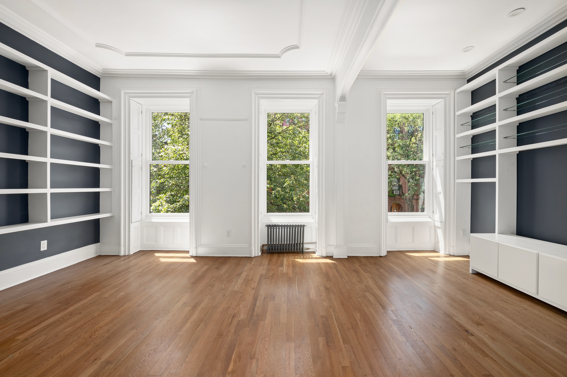 73 St James Place, Unit 2 Brooklyn, NY 11238 - Photo 6 of 15 a view of an empty room with a window and wooden floor