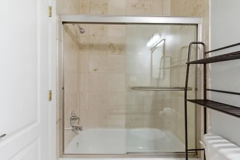 a bathroom with a glass shower door