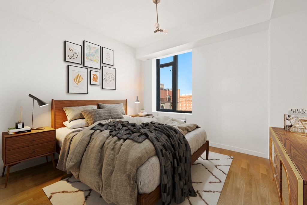 122 West Street, Unit PHA Brooklyn, NY 11222 - Photo 6 of 14 a bed sitting in a bedroom next to a window with a dresser