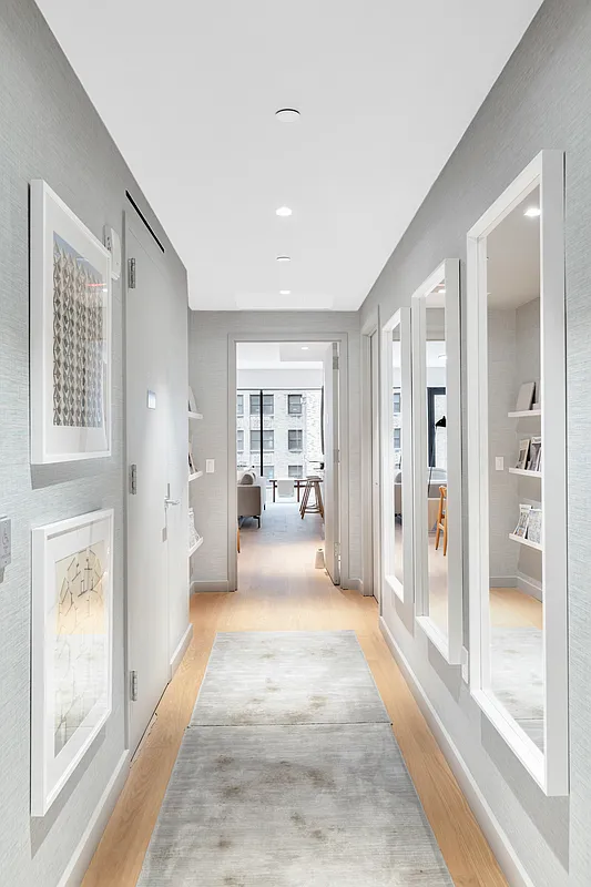 139 East 23rd Street, Unit 7 Manhattan, NY 10010 - Photo 6 of 17 a view of a hallway with a livingroom and furniture