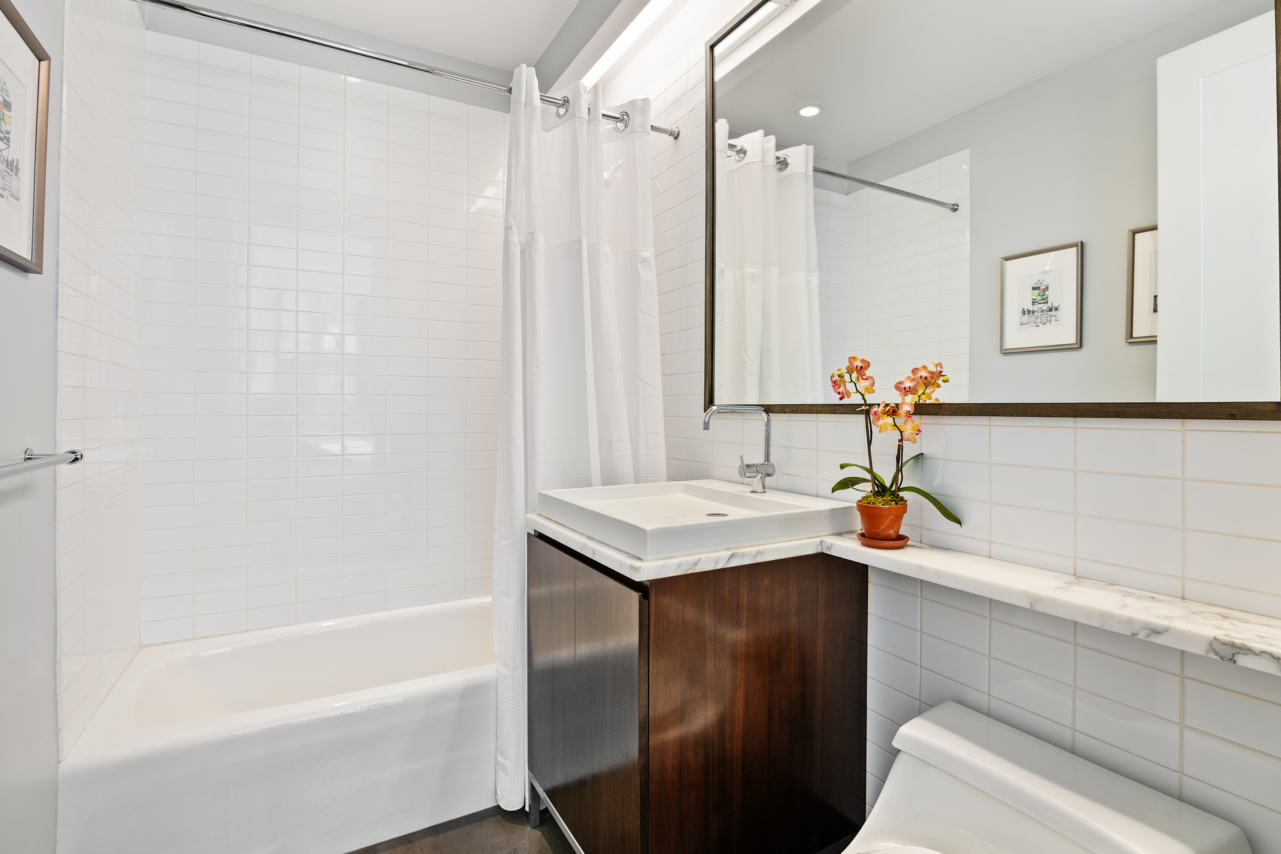 260 Park Avenue South, Unit 6I Manhattan, NY 10010 - Photo 7 of 9 a bathroom with a sink and a bathtub