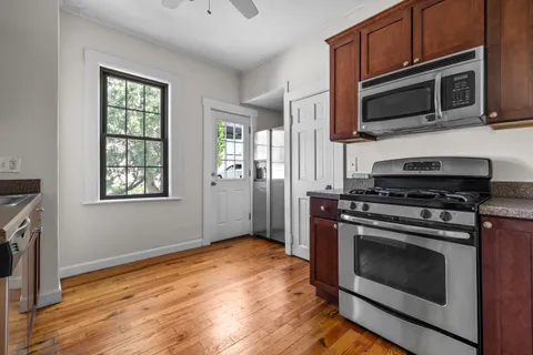 a kitchen with stainless steel appliances a stove microwave and sink