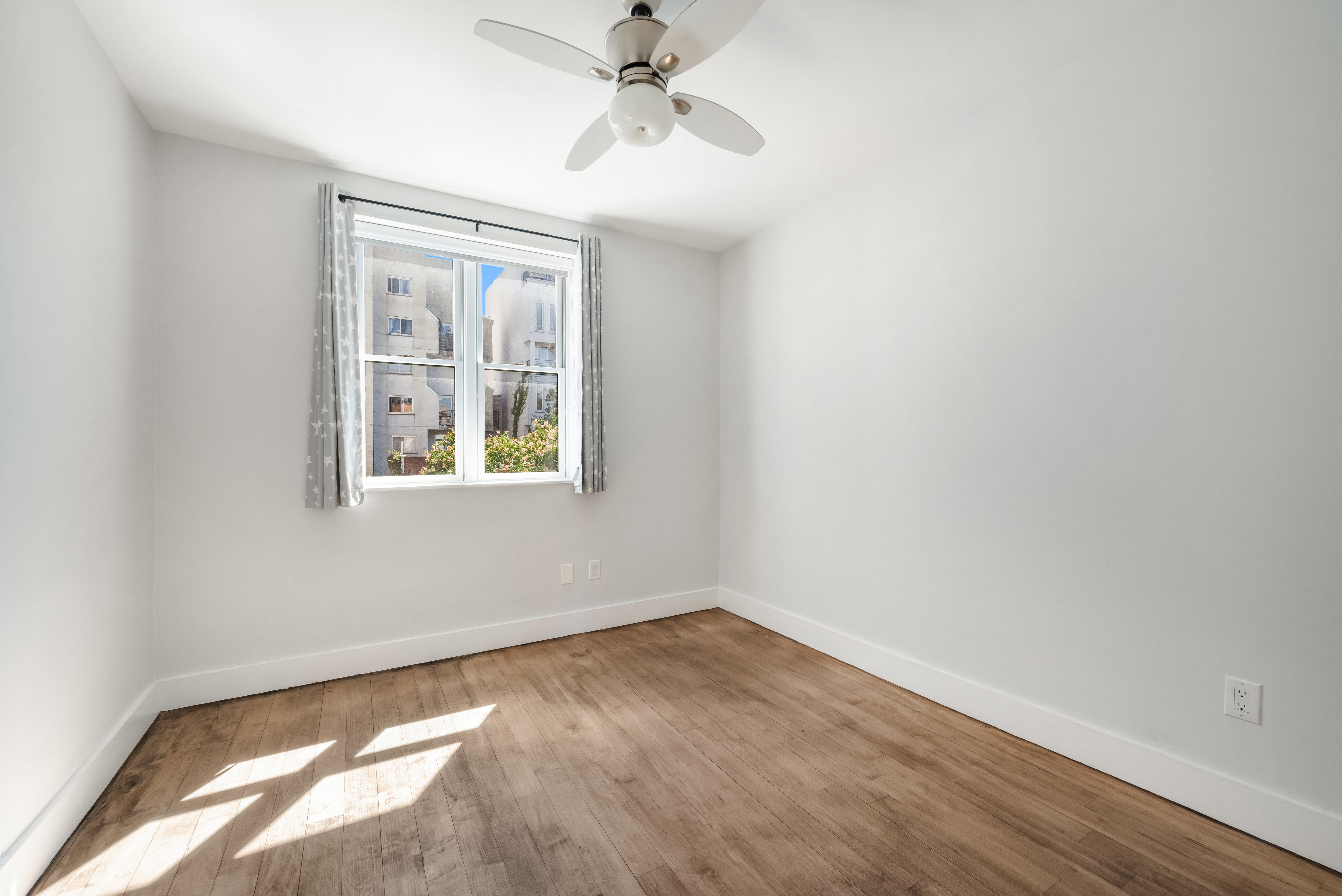 252 Richardson Street, Unit 3L Brooklyn, NY 11222 - Photo 6 of 12 wooden floor in an empty room with a window