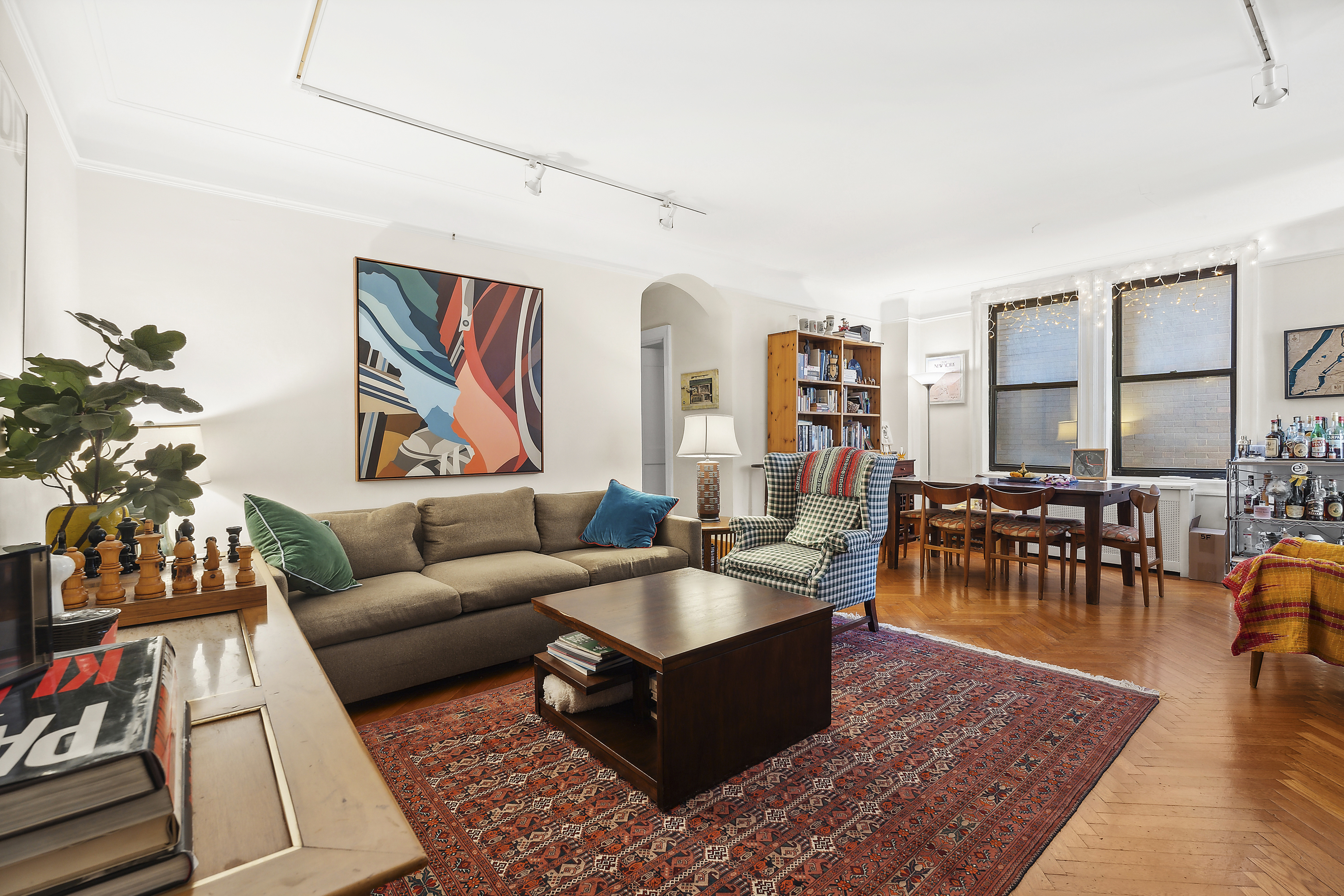 a living room with furniture a rug and a large window