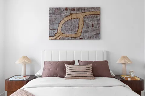 a bedroom with a bed and a lamp