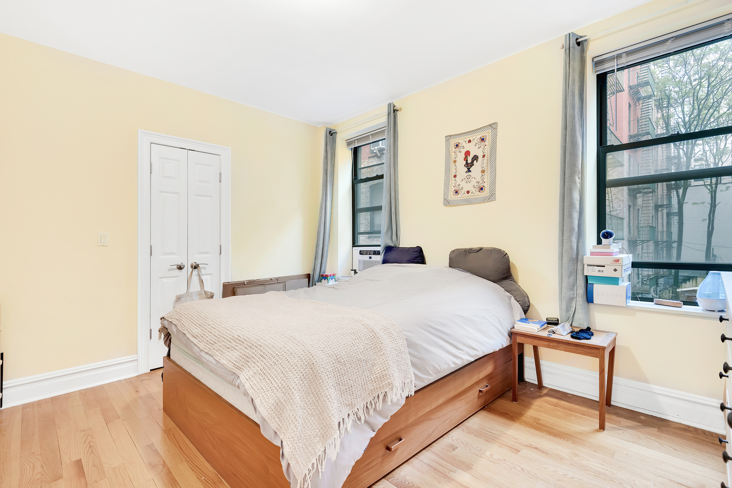 750 Riverside Drive, Unit 3E Manhattan, NY 10031 - Photo 4 of 8 a bedroom with a bed and a window