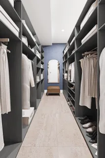 a hallway with a white car parked in the back