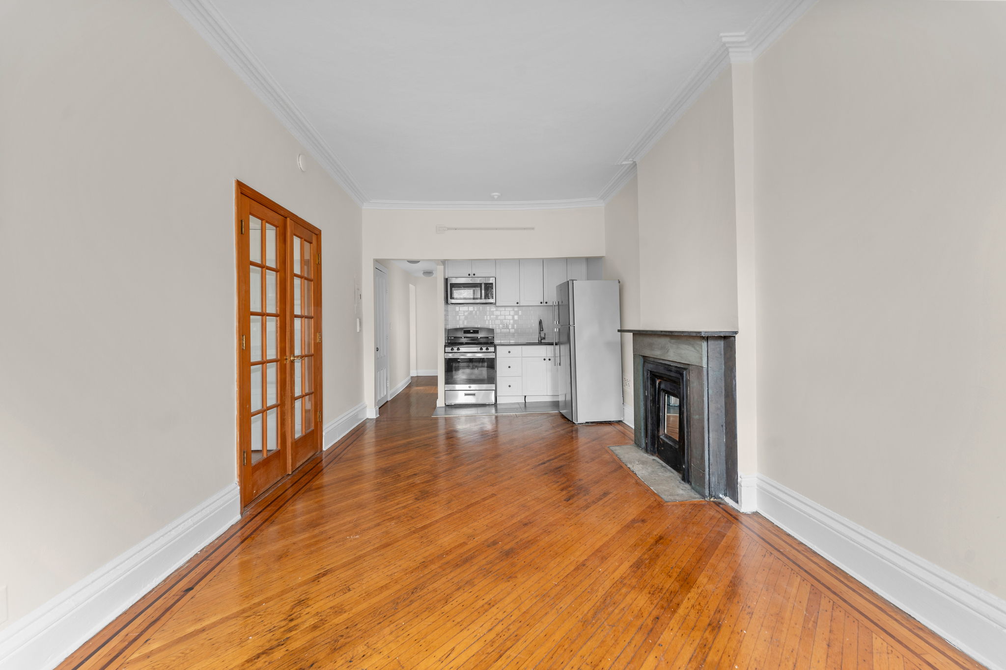 149 Sterling Place, Unit 4 Brooklyn, NY 11217 - Photo 2 of 9 a view of empty room with wooden floor and fireplace