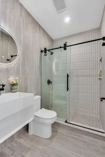 a bathroom with a toilet a sink and shower