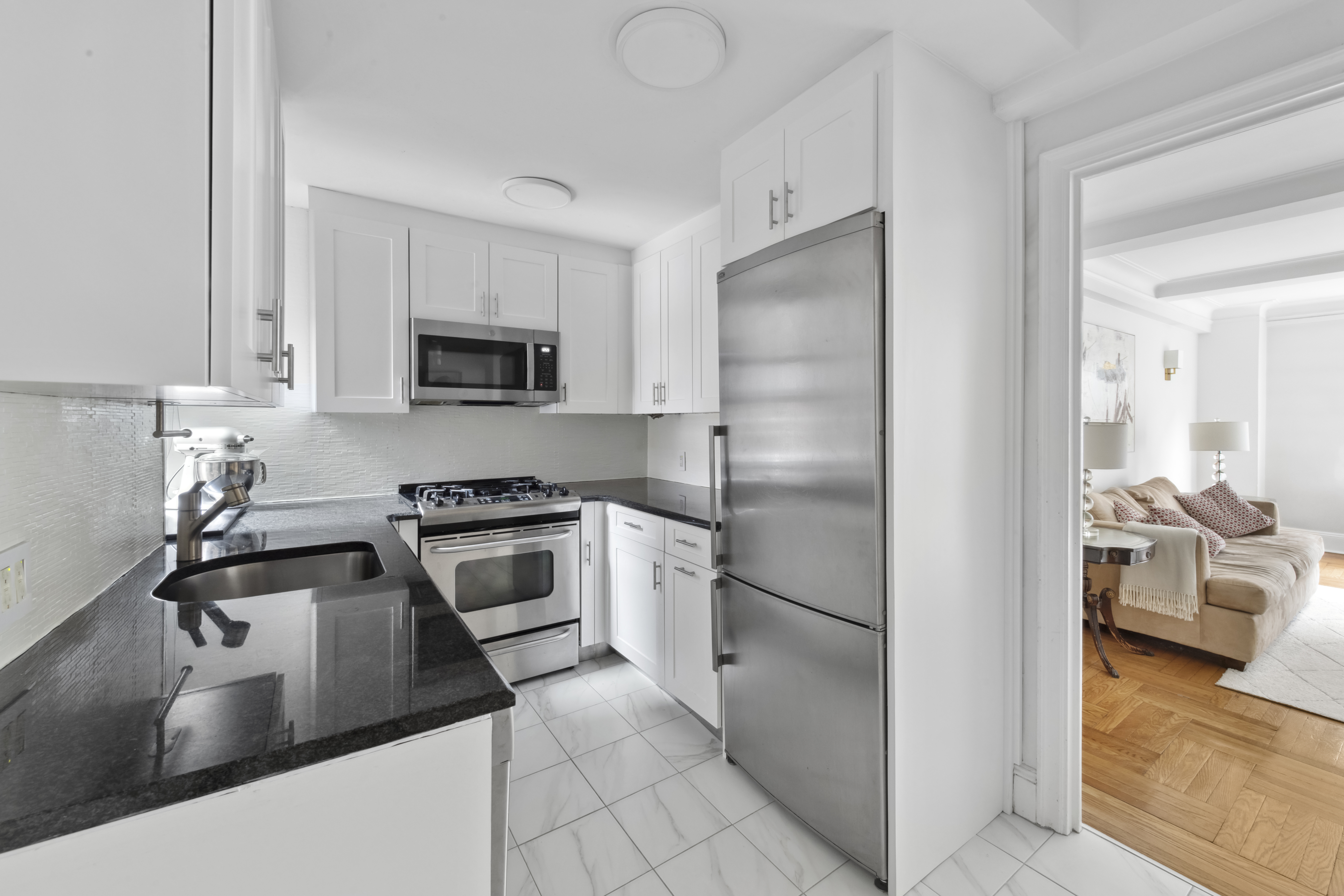 333 East 53rd Street, Unit 3KL Manhattan, NY 10022 - Photo 4 of 10 a kitchen with a refrigerator sink and stove