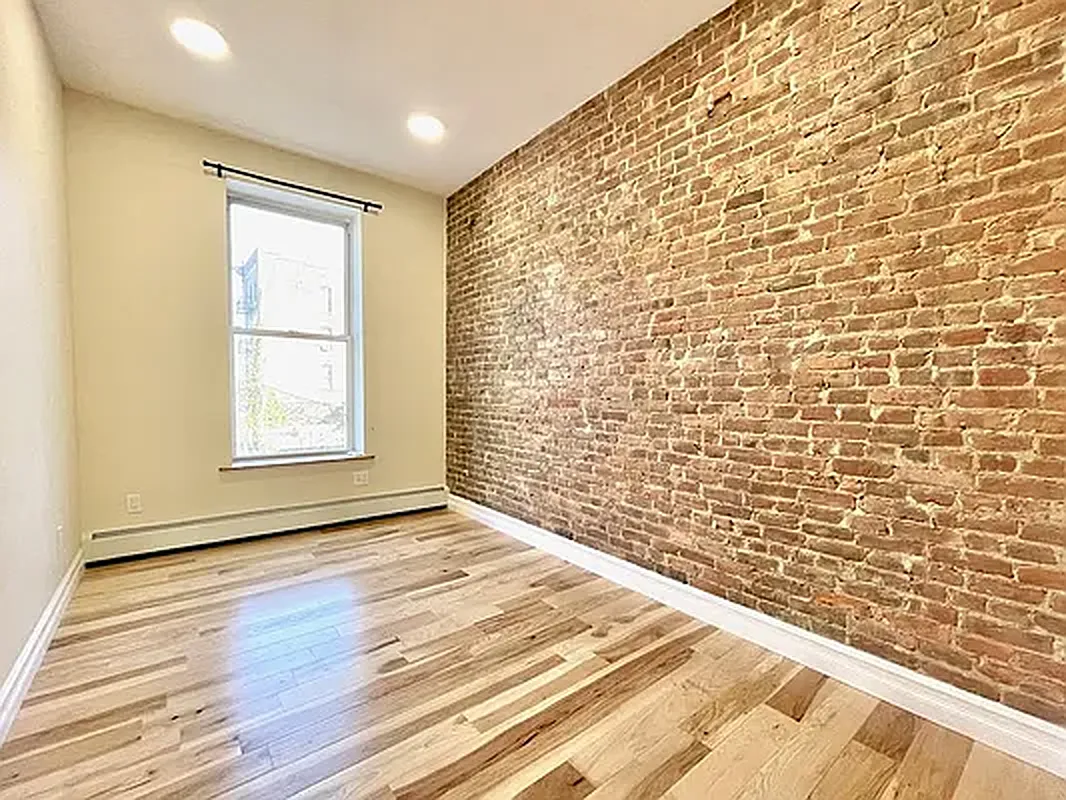 1120 Greene Avenue, Unit 1 Brooklyn, NY 11221 - Photo 5 of 13 a view of an empty room with a window and wooden floor