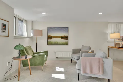 a living room with furniture and a lamp
