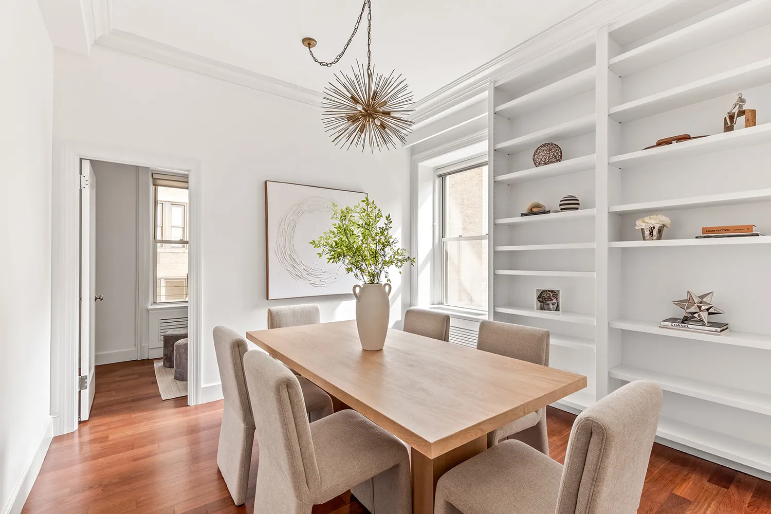 a view of a dining room with furniture and wooden floor