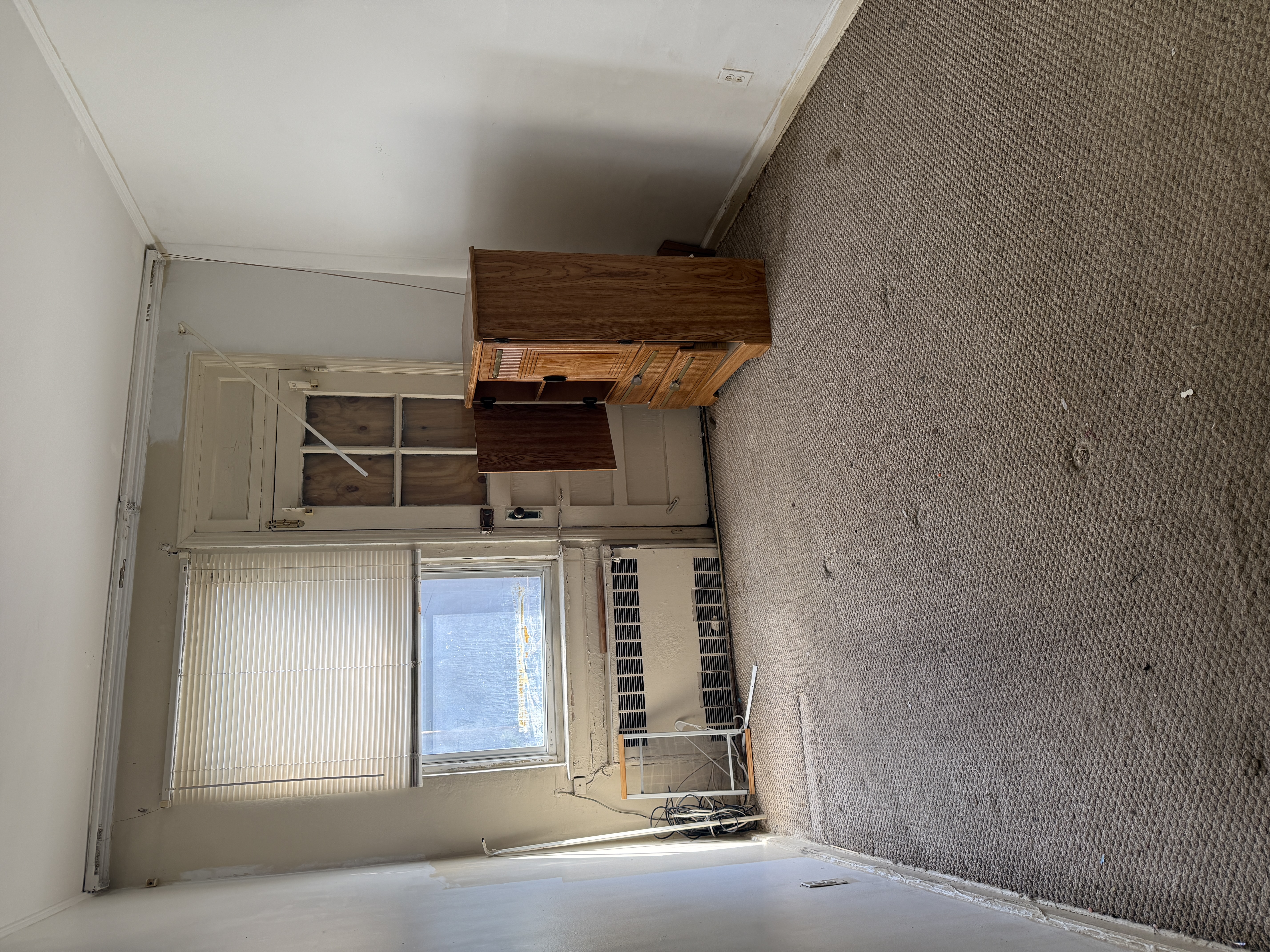 9420 Avenue B Brooklyn, NY 11236 - Photo 3 of 4 a view of an empty room with a fireplace and a window