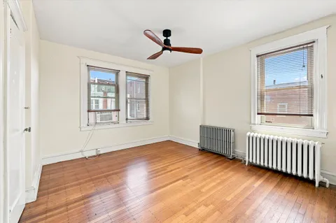 a view of an empty room with closet and a window