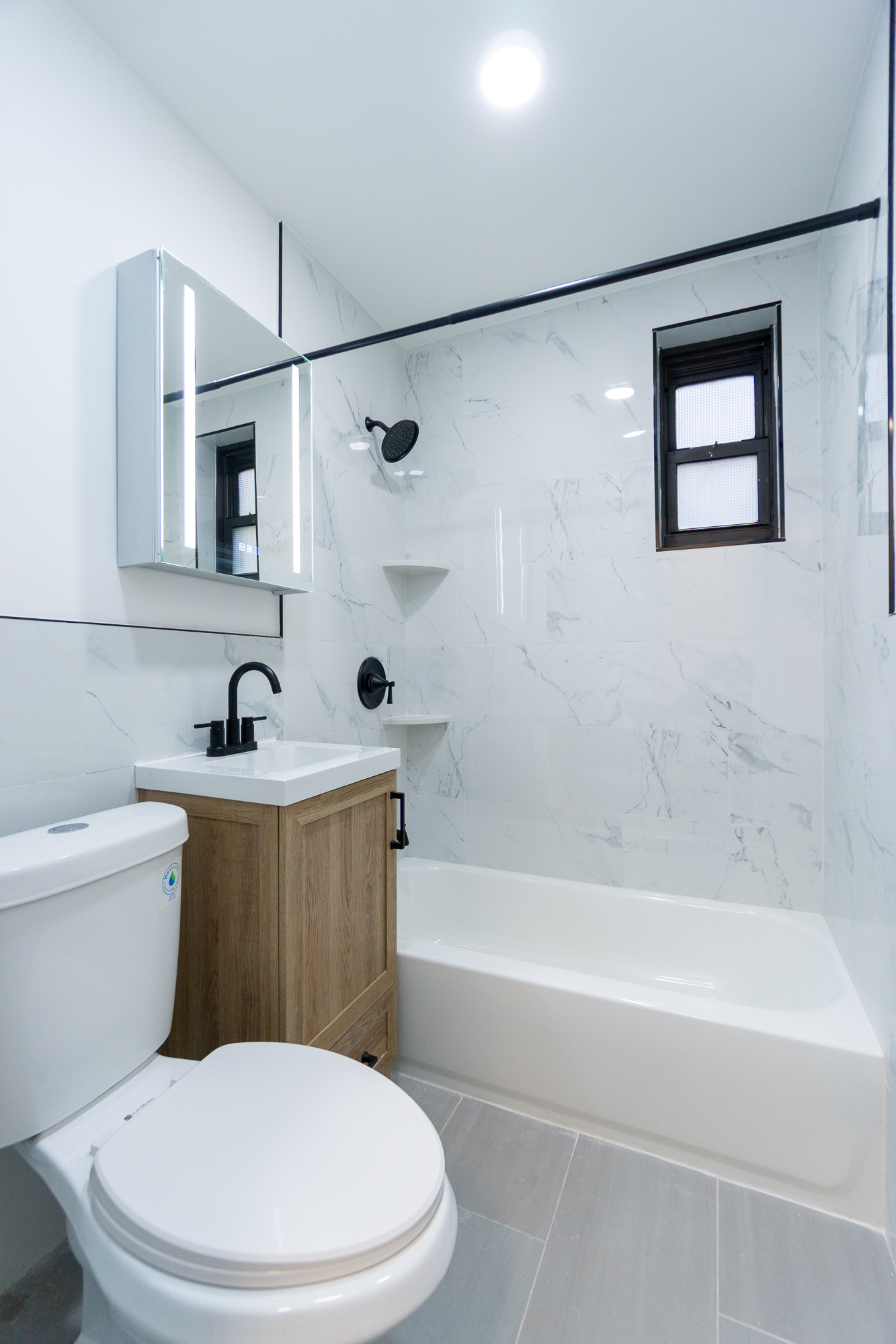 205 2nd Avenue, Unit 2C Manhattan, NY 10003 - Photo 8 of 15 a white toilet sitting next to a bath tub