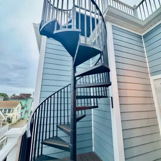 a bedroom with a bed a couch and dresser