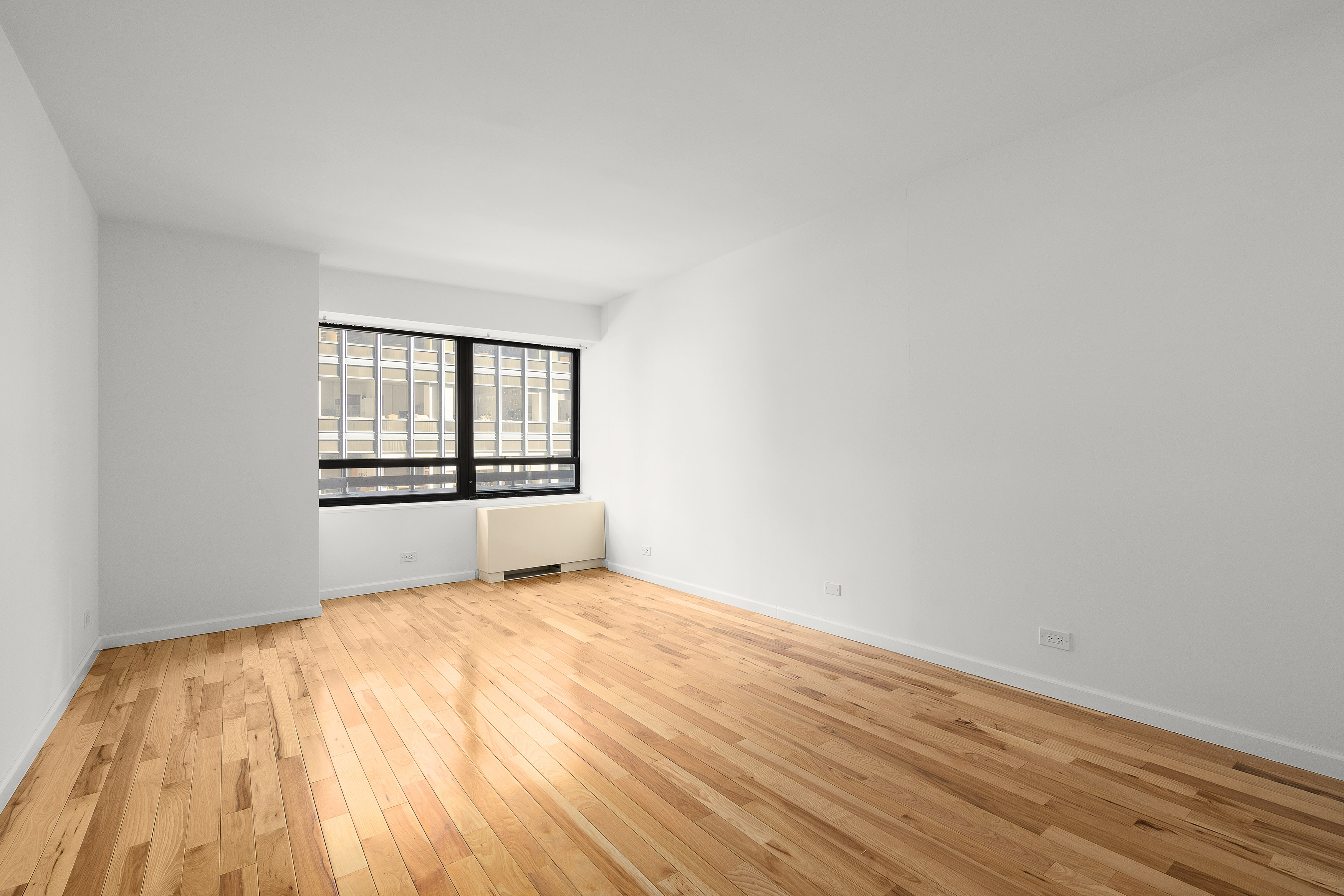 240 East 47th Street, Unit 4B Manhattan, NY 10017 - Photo 8 of 25 wooden floor in an empty room