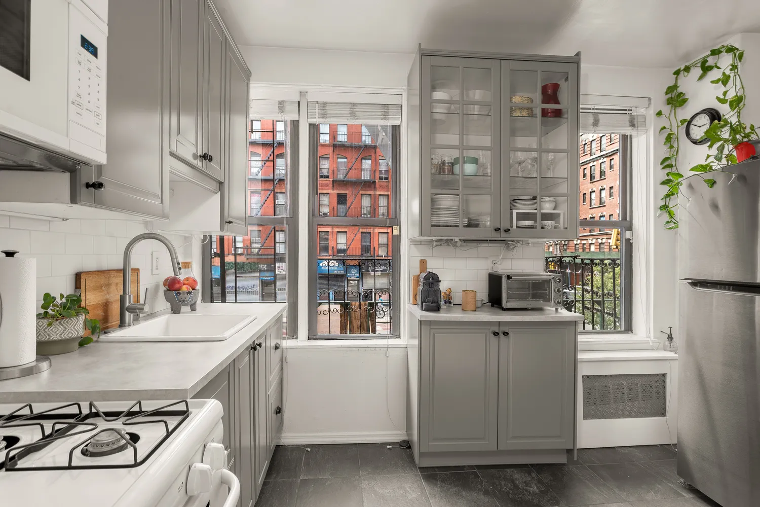 a kitchen with a sink stove and cabinets