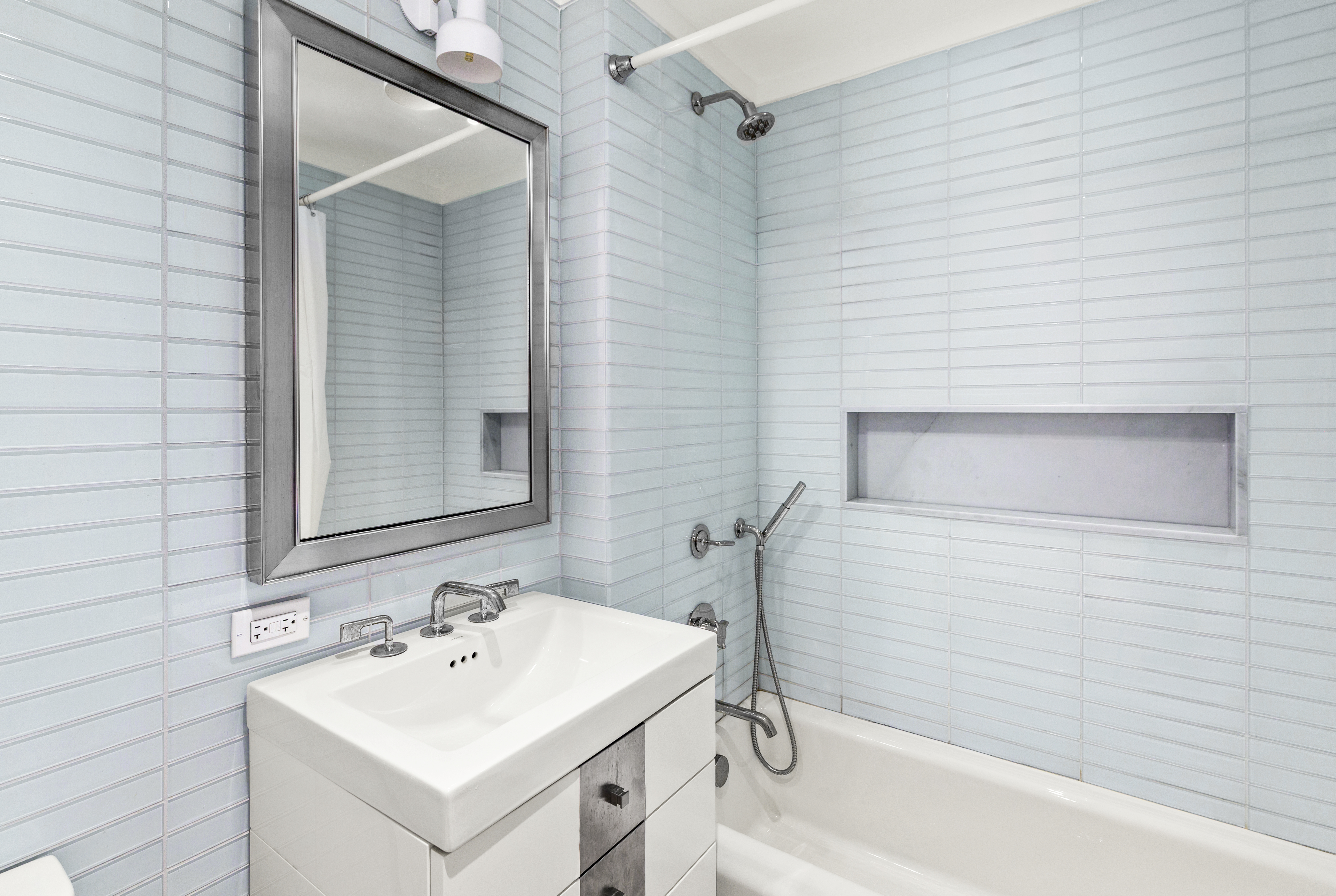 212 Warren Street, Unit 3B Manhattan, NY 10282 - Photo 7 of 11 a bathroom with a sink and a bathtub