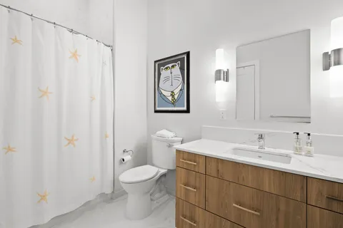 a bathroom with a toilet sink and mirror