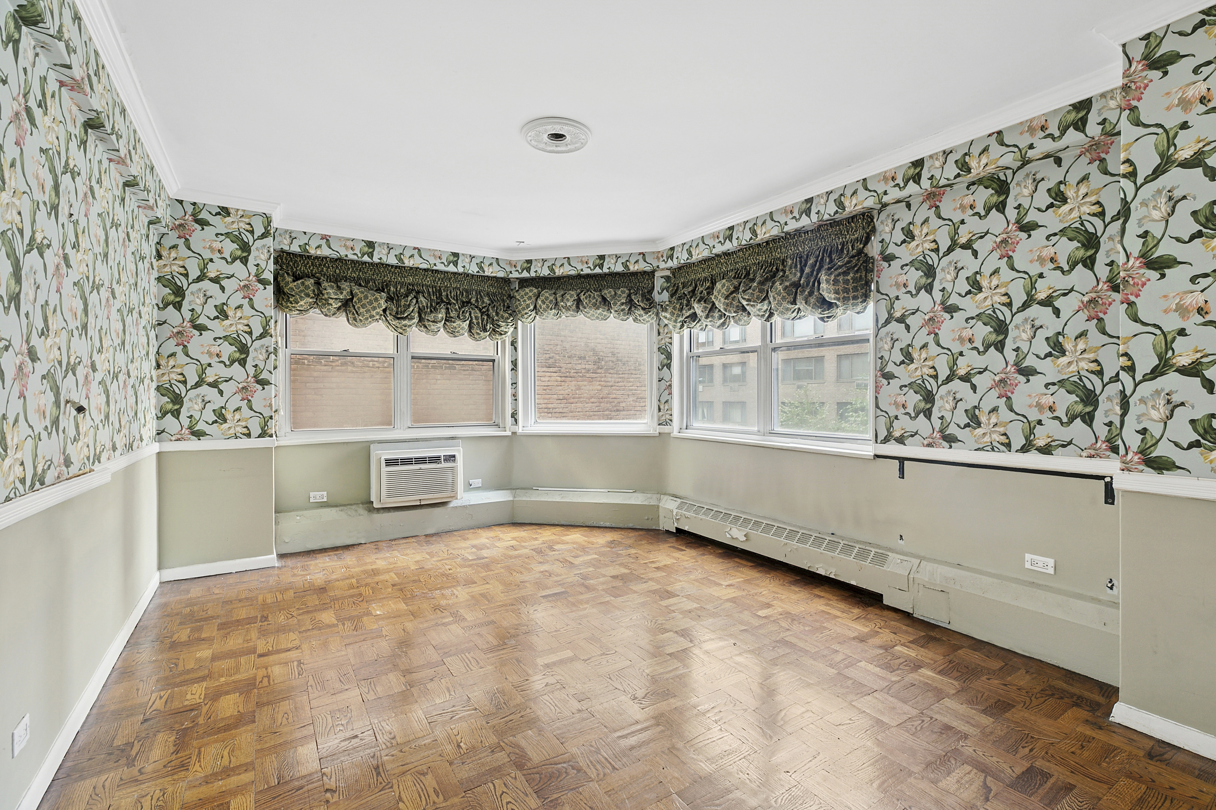 1175 York Avenue, Unit 6C Manhattan, NY 10065 - Photo 6 of 12 a view of a big room with wooden floor and windows