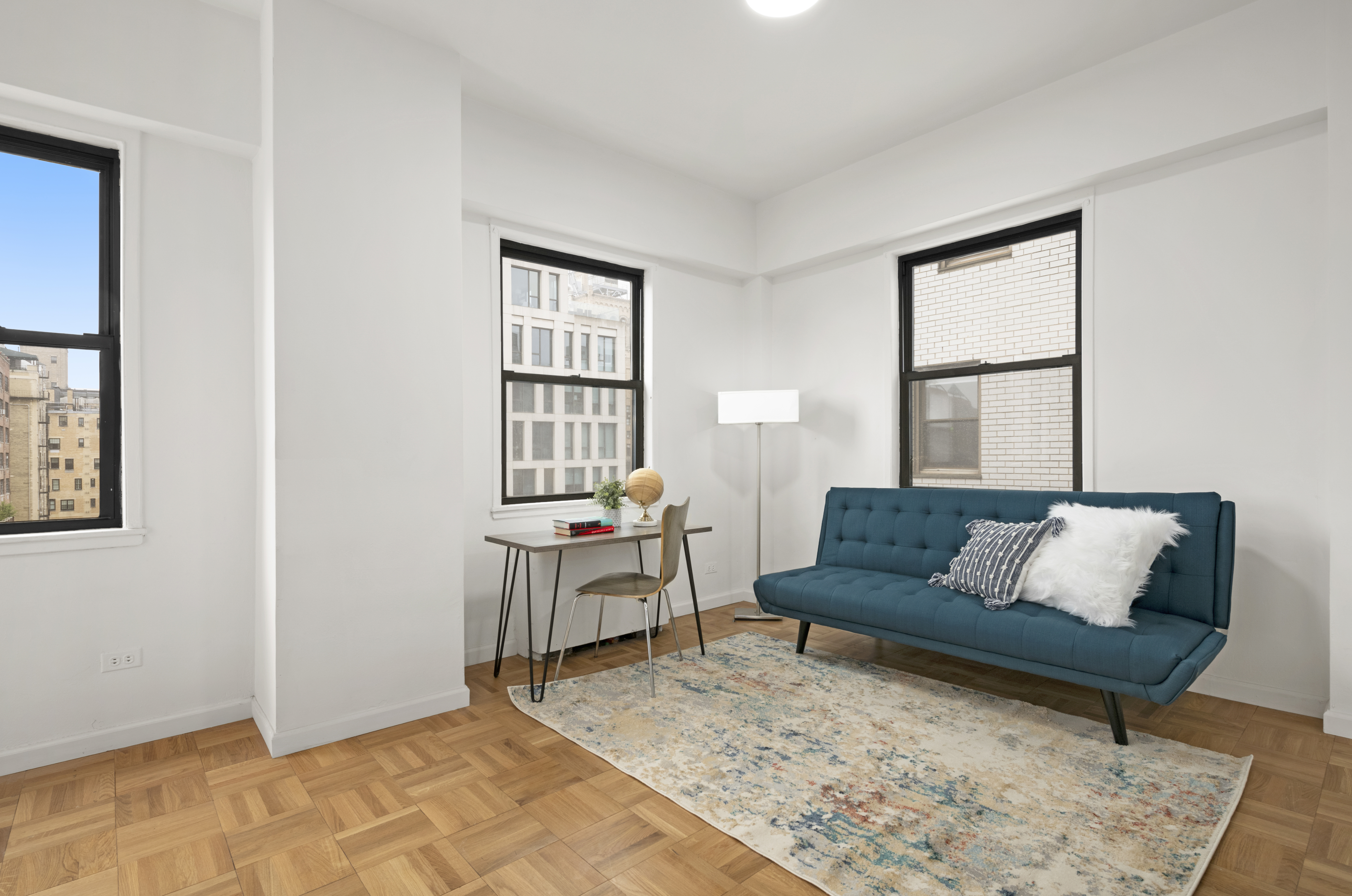 201 East 21st Street, Unit 15C Manhattan, NY 10010 - Photo 5 of 9 a living room with furniture and a window