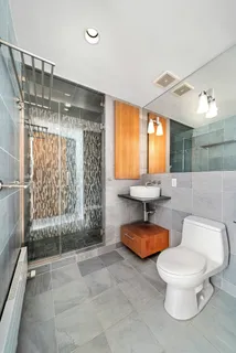 a bathroom with a toilet and a shower