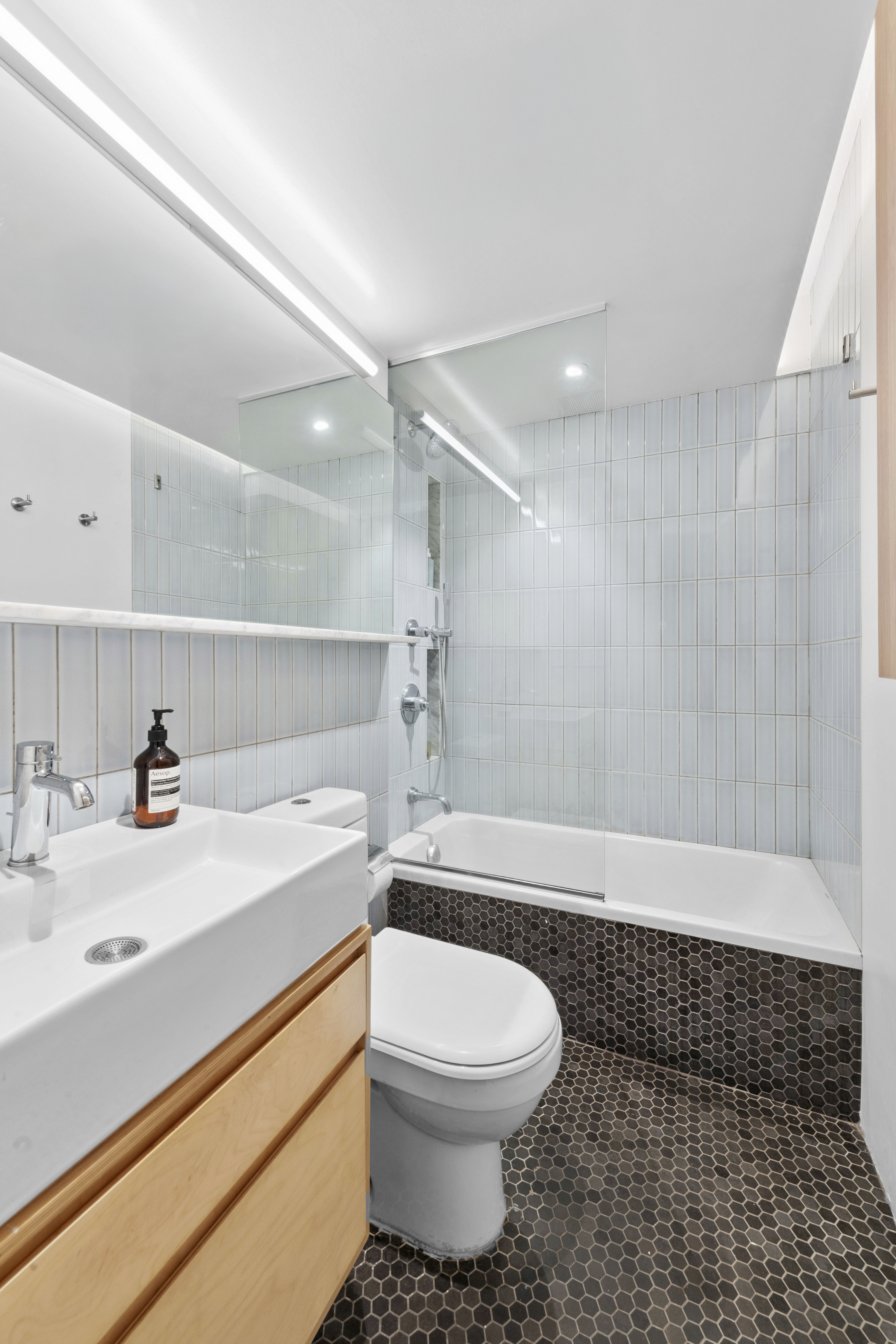 34 Plaza Street East, Unit 110 Brooklyn, NY 11238 - Photo 10 of 12 a bathroom with a sink a toilet and shower
