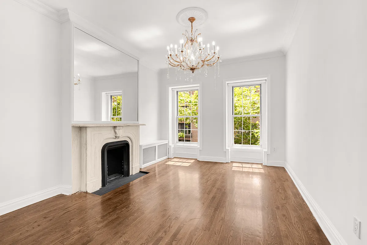 177 East 70th Street Manhattan, NY 10021 - Photo 6 of 14 a view of an empty room with a window and wooden floor