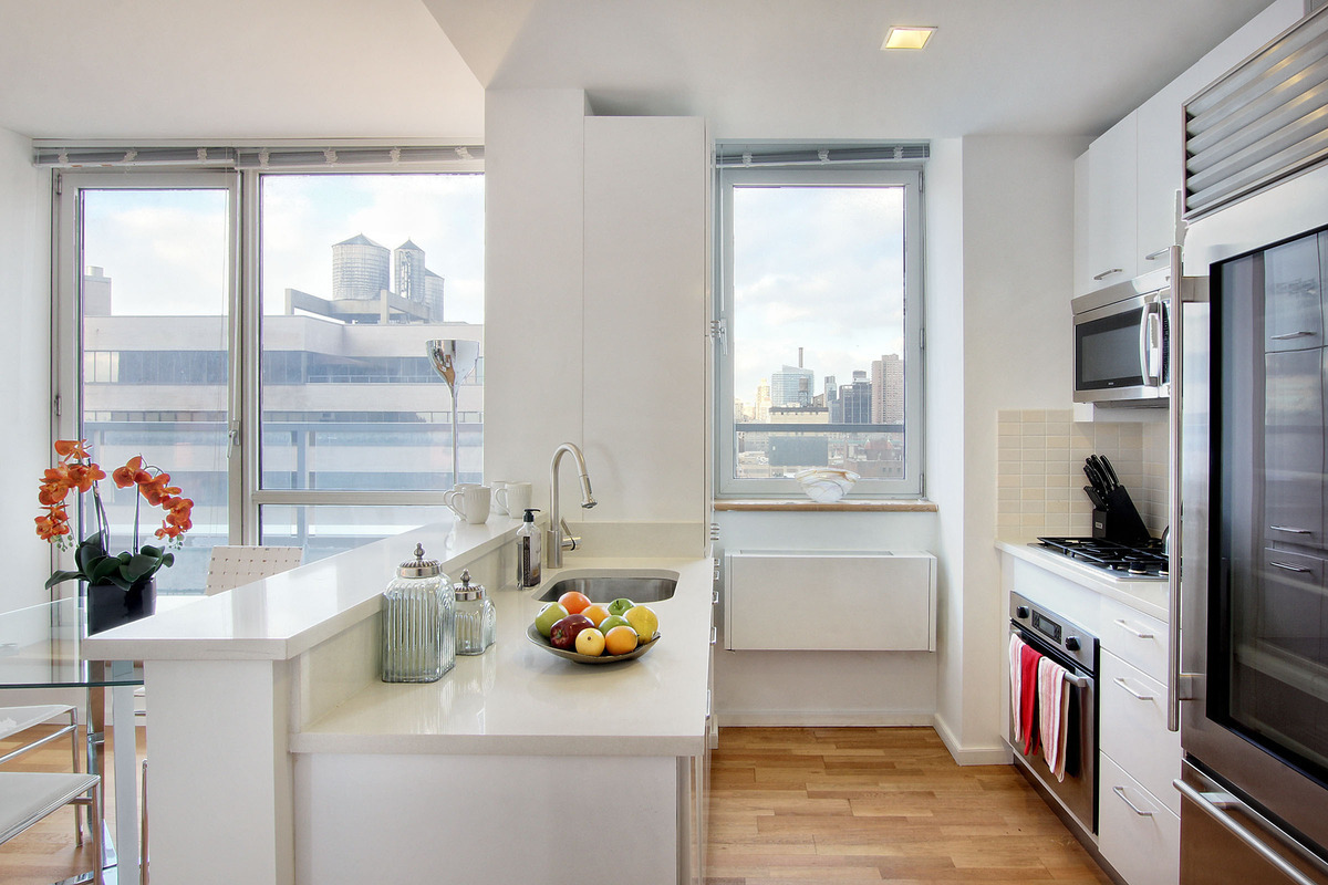 635 West 42nd Street, Unit 10A Manhattan, NY 10036 - Photo 2 of 7 a kitchen with a refrigerator and a sink