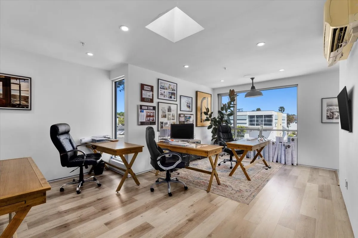 a workspace with a desk and chair with wooden floor