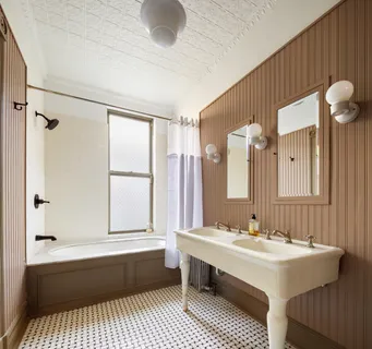 a living room with fireplace furniture and rug