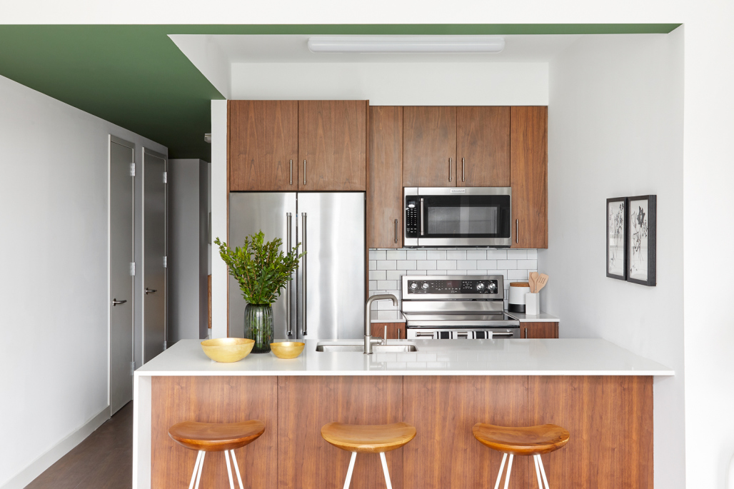 120 Nassau Street, Unit 18B Brooklyn, NY 11201 - Photo 2 of 12 a kitchen with stainless steel appliances a microwave a stove and white cabinets