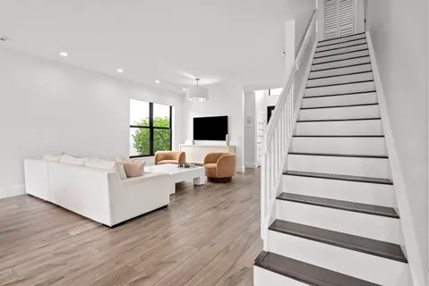 a living room with furniture and a large window